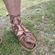 foot in sandal on grass